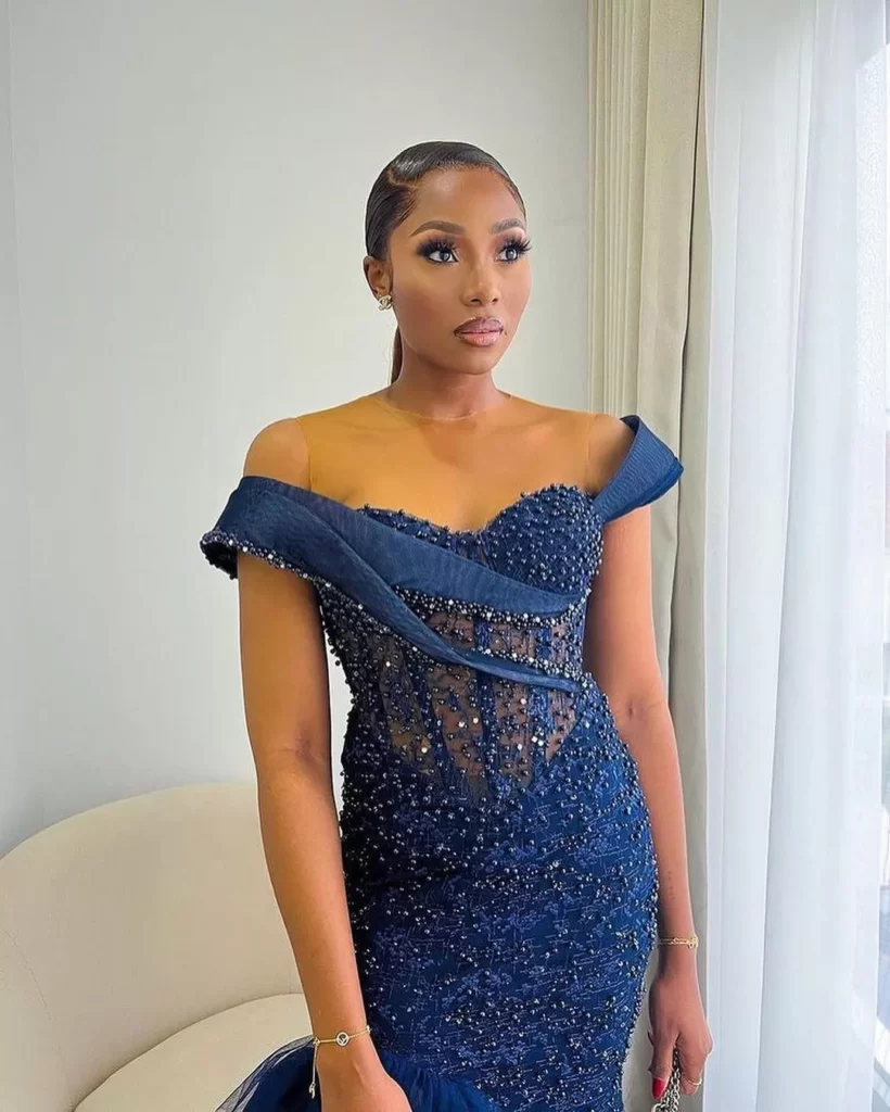 Dimma Umeh on Blue Off Shoulder Shinny Dress