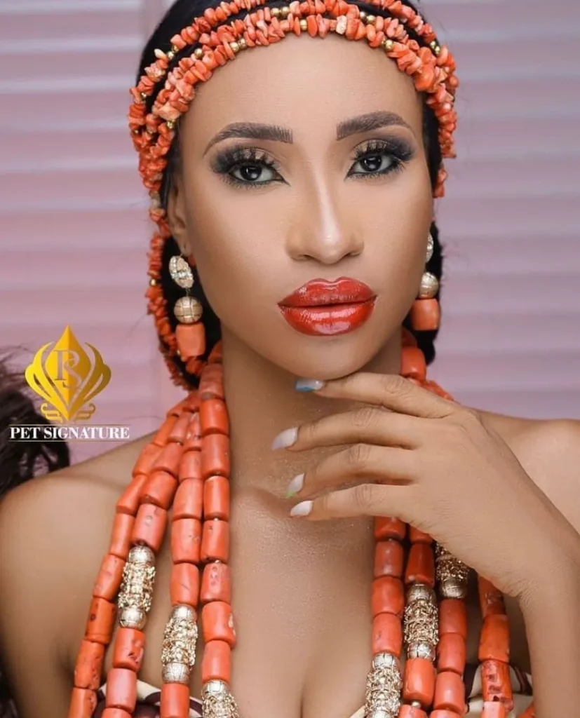 beaded traditional wedding attire with beaded crown and large neck coral beads. 