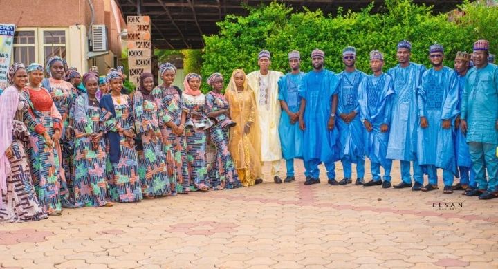 Groom and groom's men with bride and bridal squad