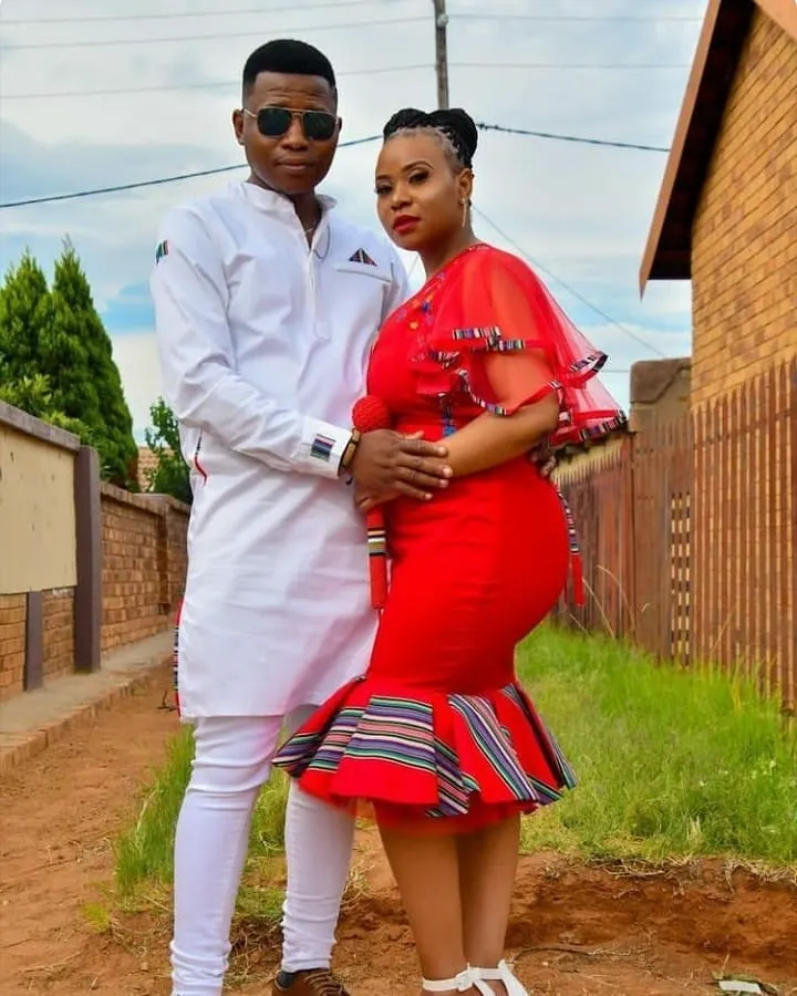 knee length Venda traditional dress with a black waist belt and a matching men's black shirt detail with traditional Venda print.