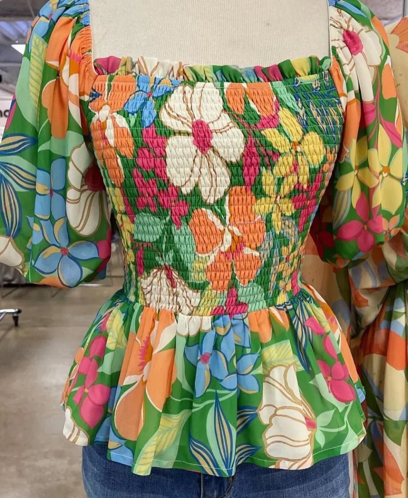 Smocked blouse with mesh sleeves