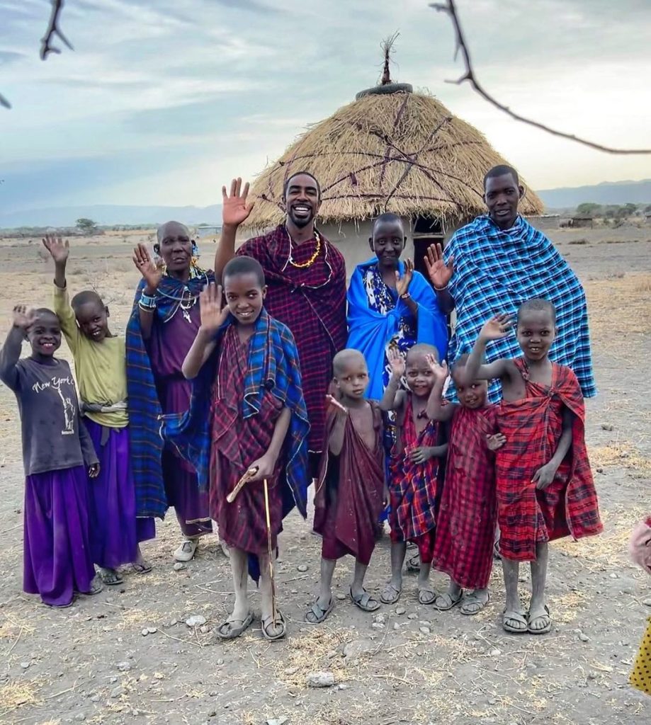 Maasai Mara man in traditional colorful clothing showing traditional Maasai jumping dance at Maasai Mara tribe. Masai Mara, Kenya