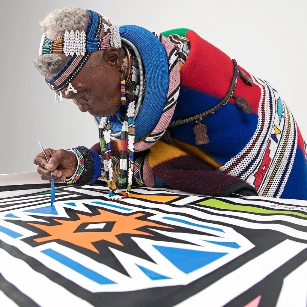 Ndebele of South Africa and Zimbabwe woman in a rich tradition of gorgeous colorful quilts and blankets entirely hand-made