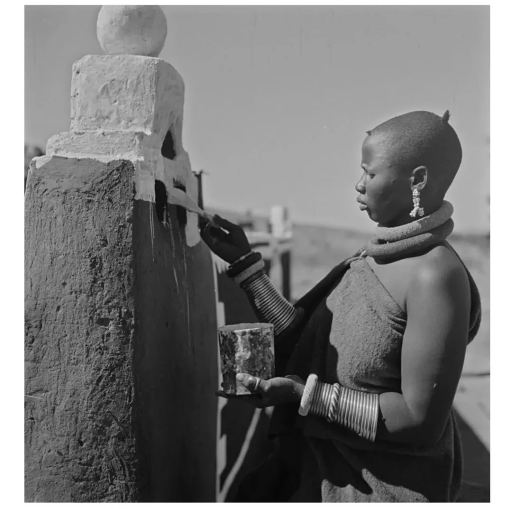 Ndebele man wears an animal skin apron, beaded breast-plates (iporiyana)