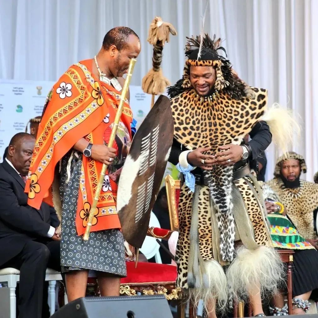 imvunulo traditional attire: black top with black patterned skirt, colourful beaded apron and arm band, leopard skin bib