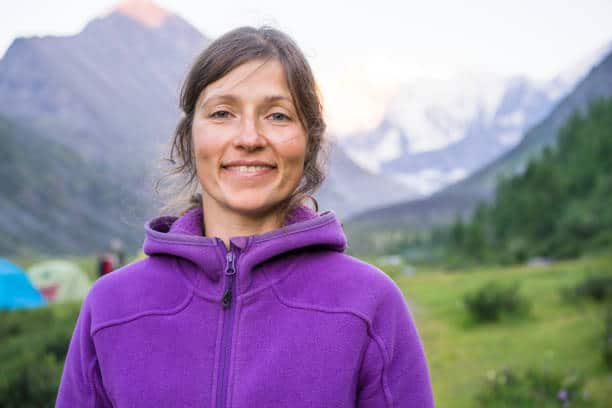 Young woman camping in fleece jacket
