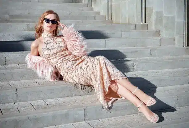 Pink halter sequined maxi dress and white sandal heels