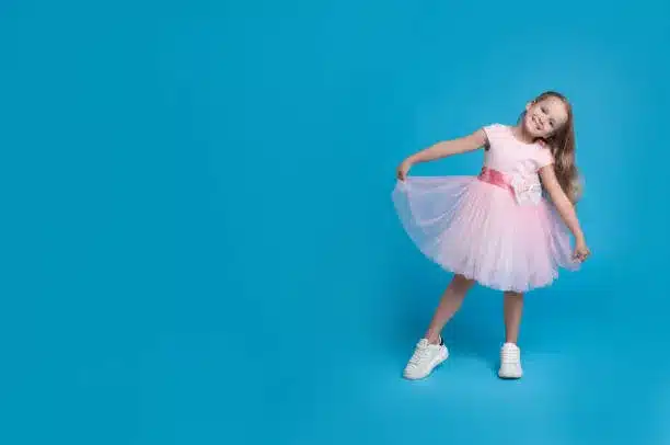 Baby pink bouffant dress with white lace up shoes