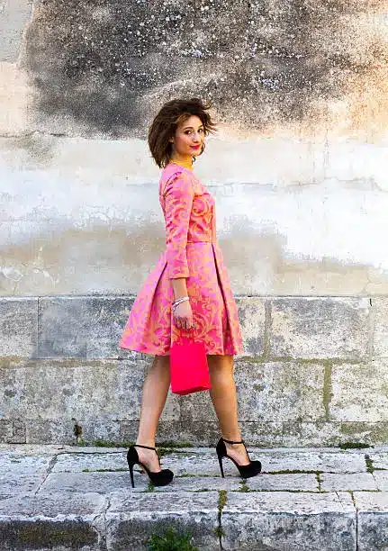 Long sleeve pink print dress with black cross-strap platform heels